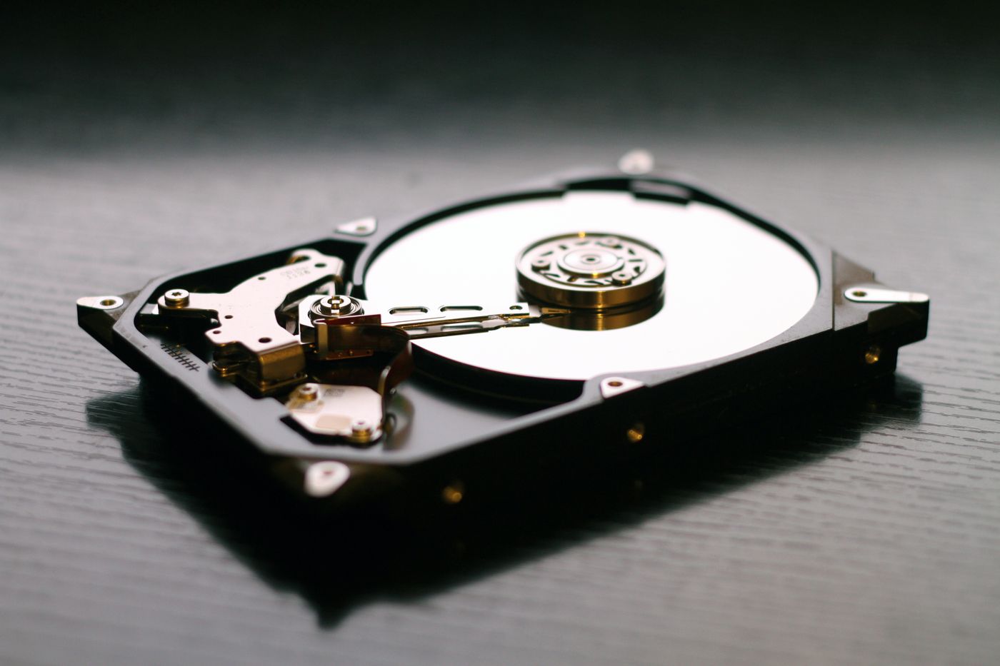 Three 24TB drives on a forensic recovery workbench
