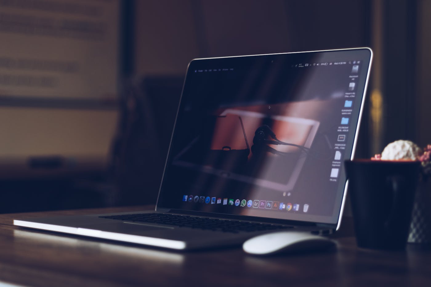 MacBook at a workstation — recovered footage back in post-production